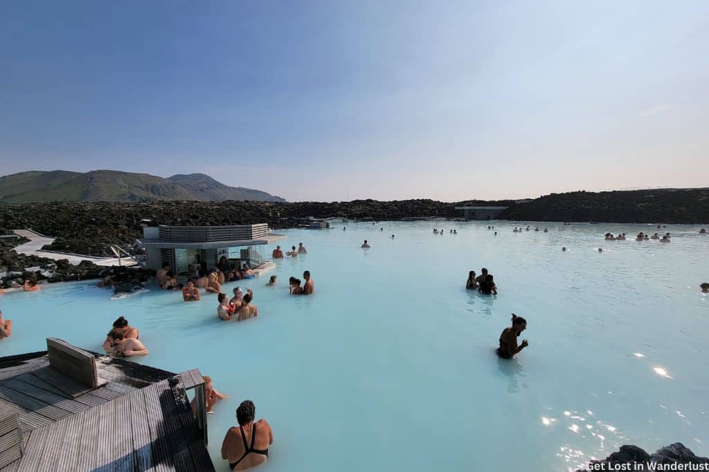 A small crowd relaxing in the waters of the Blue Lagoon.