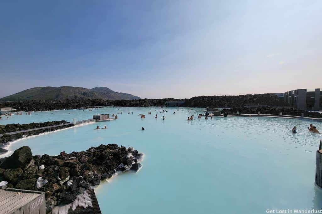 Bright blue waters of the Blue Lagoon with people relaxing.