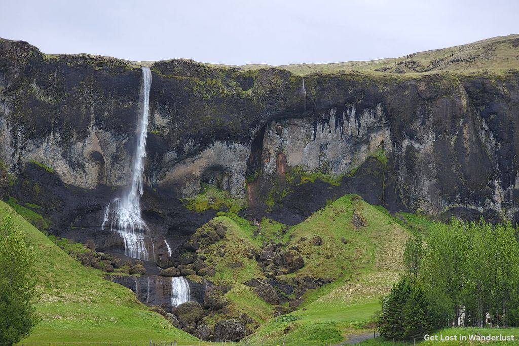 Foss á Síðu, a tall Icelandic waterfall that cascades over a steep cliff.