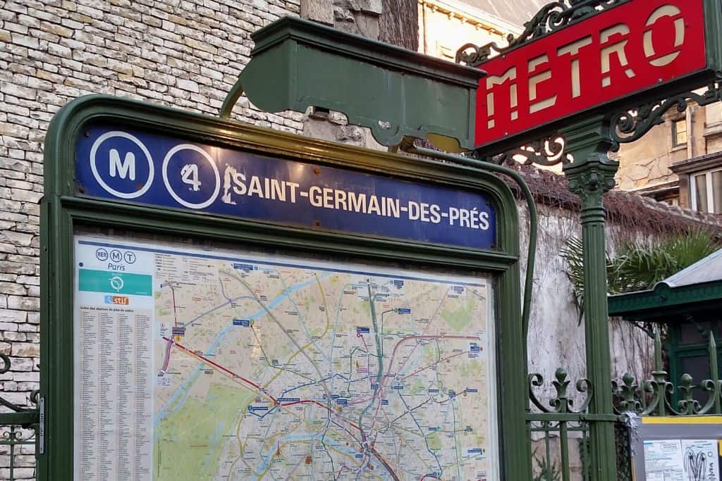 A sign and map for the Paris Metro