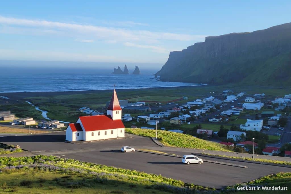 The town of Vik, featuring the church and dramatic cliffs in the background