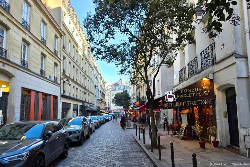 Cobblestone street in the Latin Quarter, one of the best areas to stay in Paris to walk everywhere.