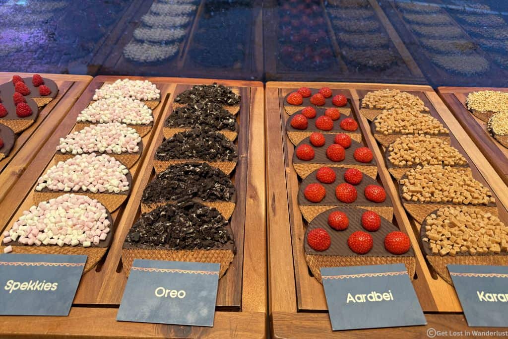 Several stroopwafels decorated with fruits and other toppings.