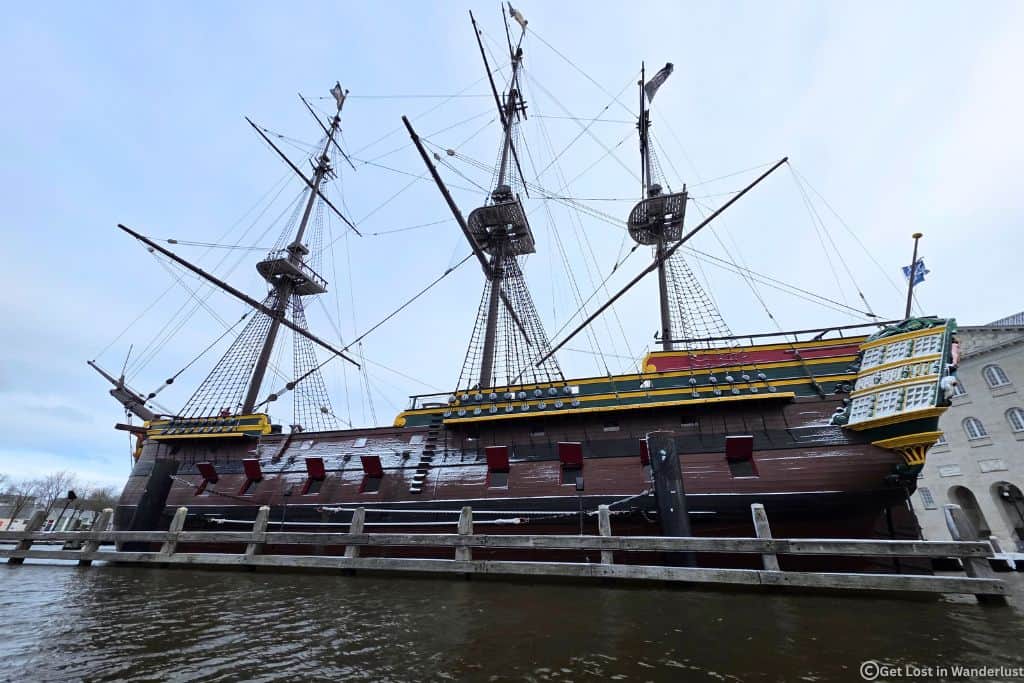 A replica of the Dutch East Indiaman Ship sitting in the water. This ship is part of the National Maritime Museum.
