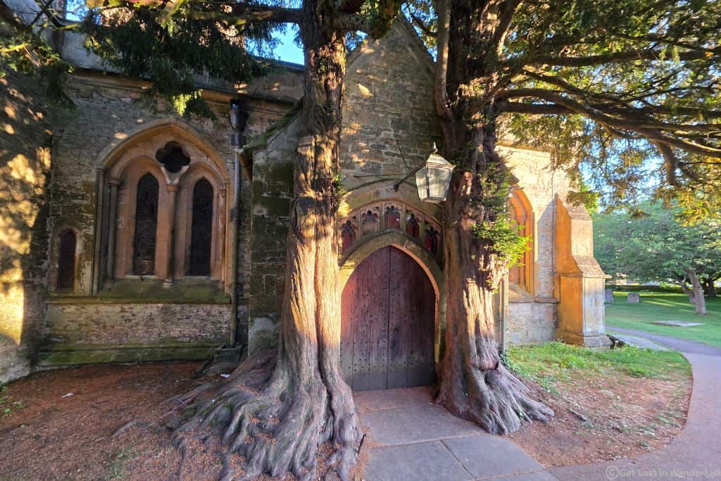 The doors of St. Edwards Church in Stow-on-the-Wold, featuring trees on each side which intertwine.