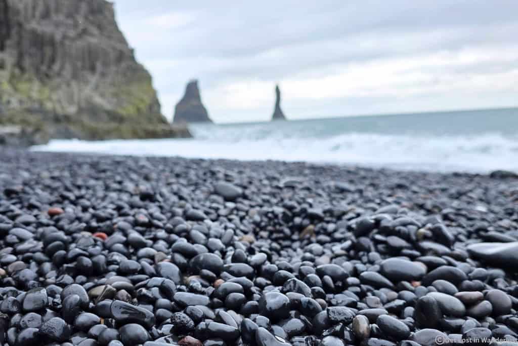 Close-up of the black volcanic stones at Reynisfjara Beach near Vík, one of Iceland's most famous black sand beaches. Another must-visit on a Iceland Ring Road Trip.