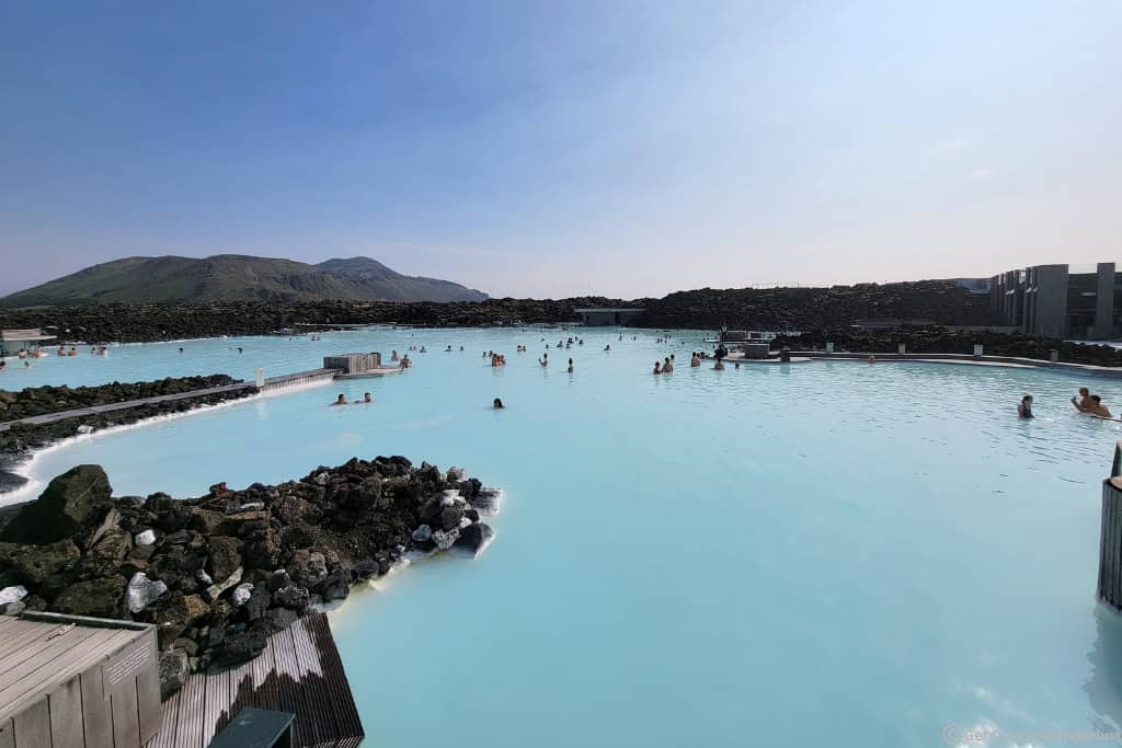 Blue Lagoon in Iceland featuring milky blue geothermal waters surrounded by black lava fields near Keflavík Airport. A popular stop when driving the Ring Road in Iceland.