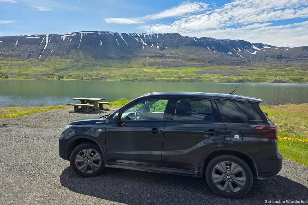 Our rental car in front of a scenic view while driving the Ring Road in Iceland.