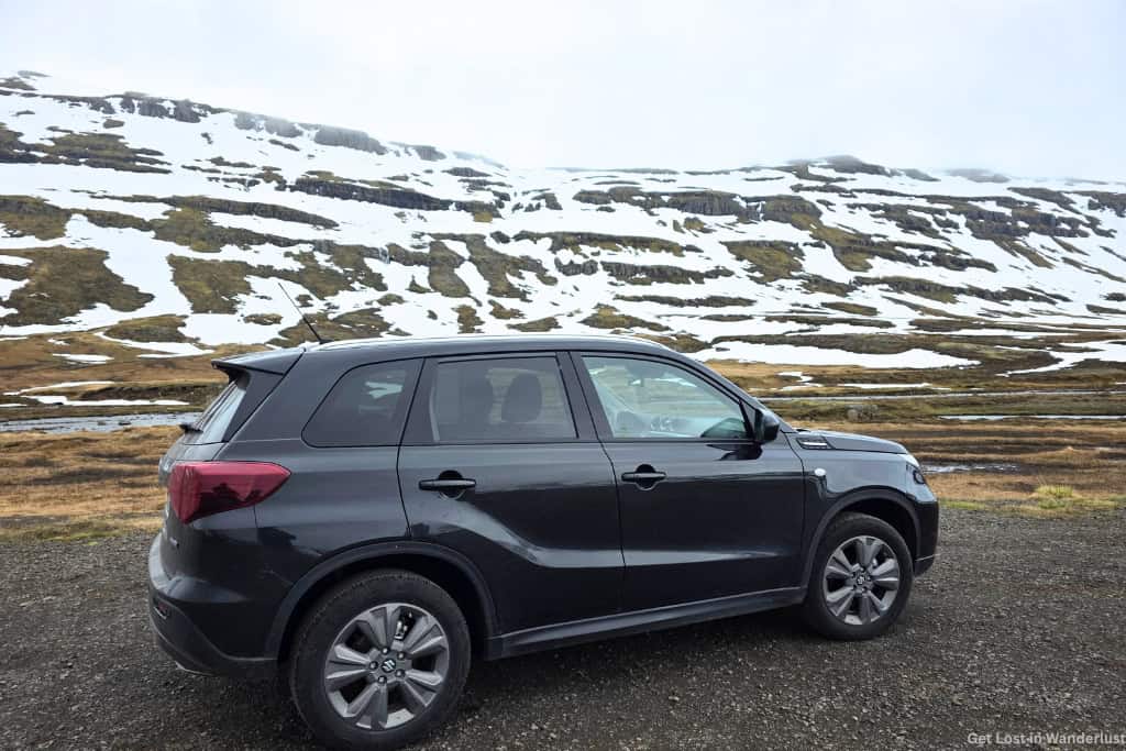 4WD Suzuki Vitara that we rented for driving the Ring Road in Iceland. In the background are the snowy mountains in East Iceland.