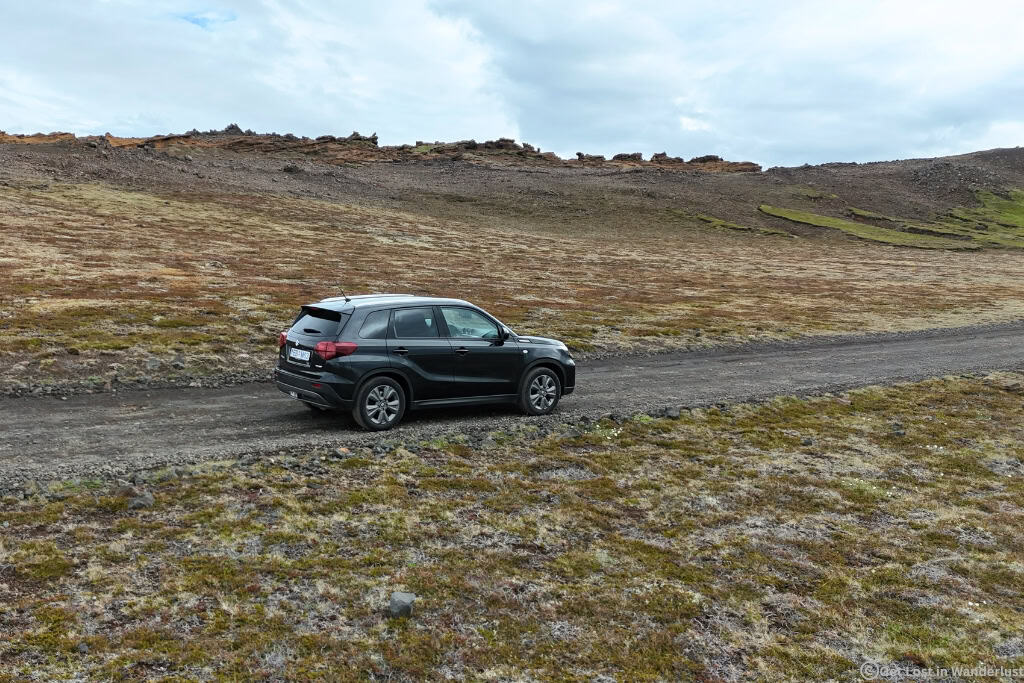 Suzuki Vitara driving a gravel road in Iceland.