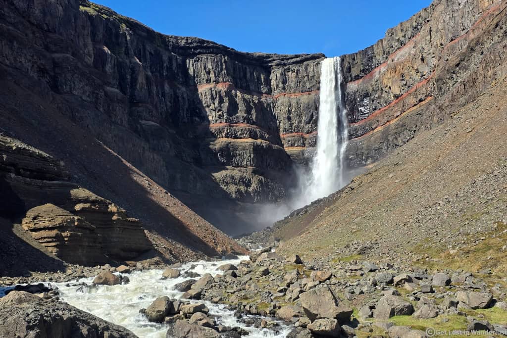 Hengifoss Waterfall near Egilsstaðir, one of the tallest waterfalls in Iceland known for its striking red clay layers.