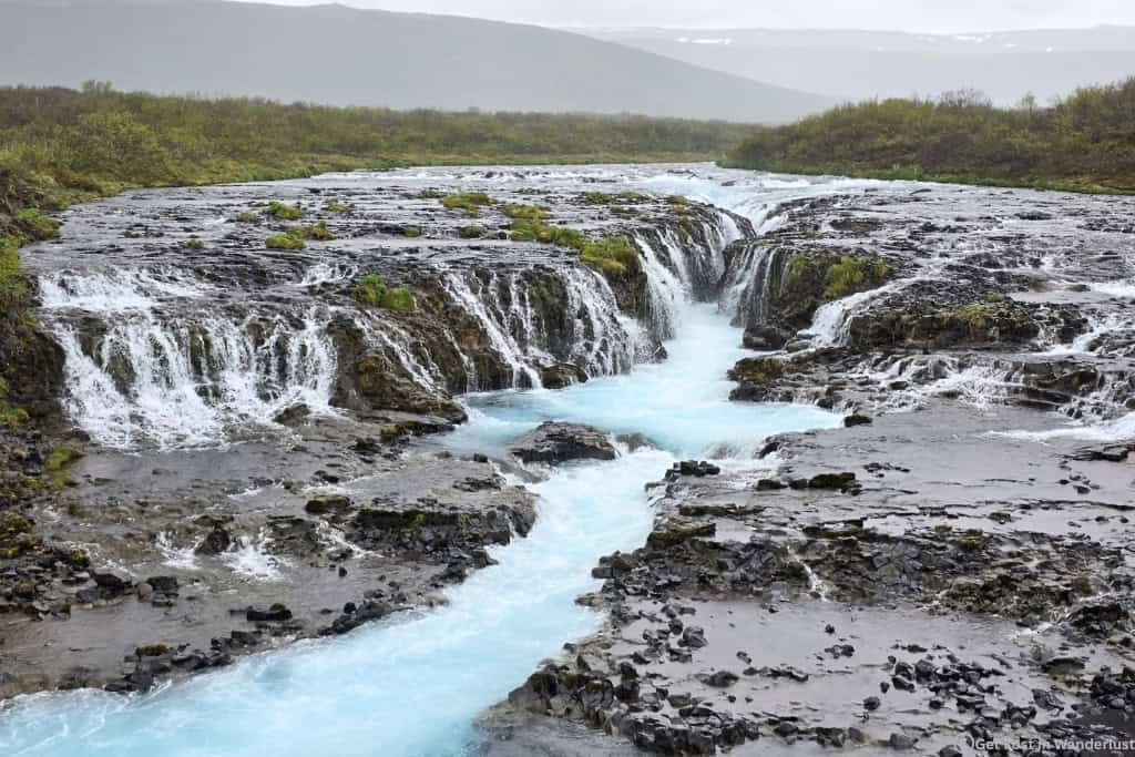 Brúarfoss Waterfall near Iceland's Golden Circle with bright blue glacial water.