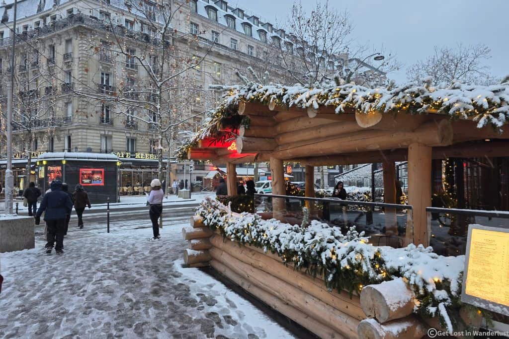 Snow-covered Christmas chalet and festive street in Paris’s 8th Arrondissement, a top choice of where to stay for Christmas in Paris.
