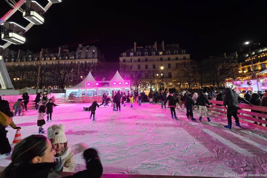 Holiday ice skating rink in Paris’s 1st Arrondissement at night during Christmas.