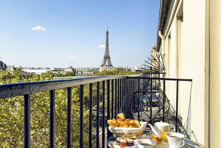 Eiffel Tower view from a private balcony at Hôtel Duquesne Eiffel in Paris. One of the best Paris Christmas hotels for Eiffel Tower views.