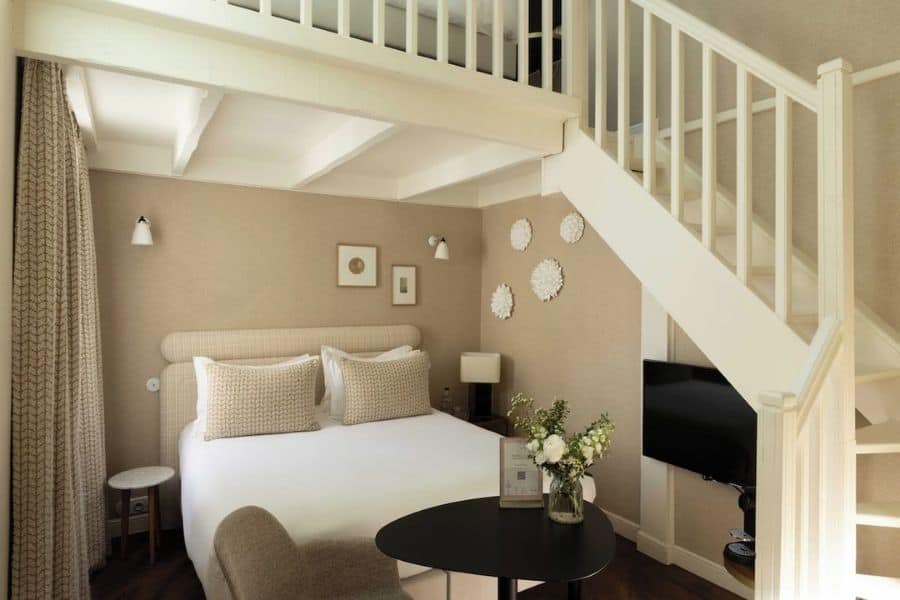 Duplex guest room with loft and staircase at Hôtel Madeleine Haussmann in Paris, the perfect place for families looking for where to stay for Christmas in Paris.