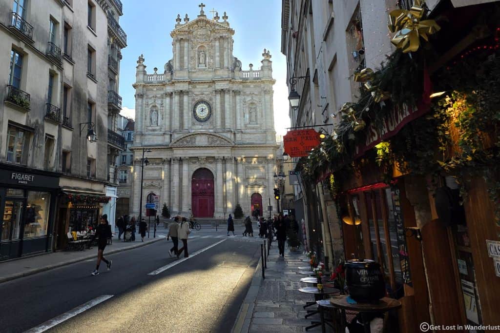 Christmas decorations along a street near Saint-Paul-Saint-Louis Church in Le Marais, Paris. If you are looking for where to stay in Paris at Christmas, Le Marais is one of the best neighborhoods.