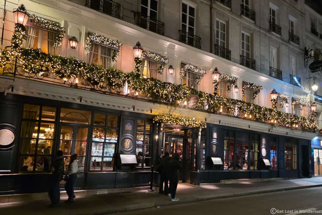 Le Procope restaurant in Paris decorated with Christmas lights and garlands