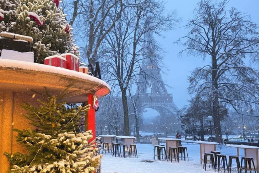Christmas market café with the snow-covered Eiffel Tower in the background