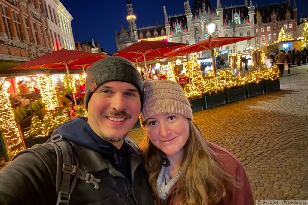 Us at Bruges Winter Glow, surrounded by Christmas lights and festive decorations in Markt Square.
